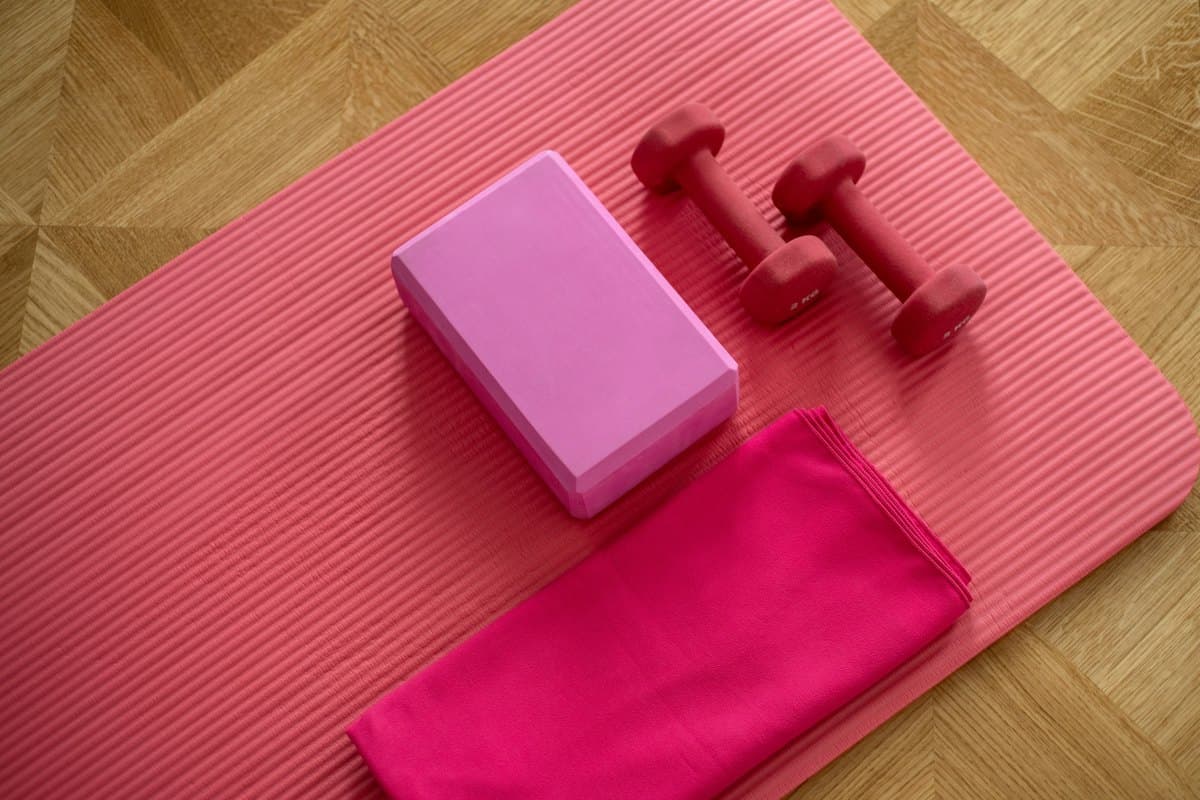 Rolled yoga mats lined against a cream wall
